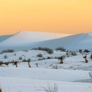 a snowy landscape with mountains in the distance