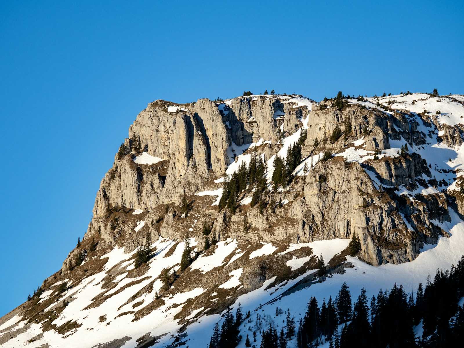 a snow covered mountain with a clear blue sky