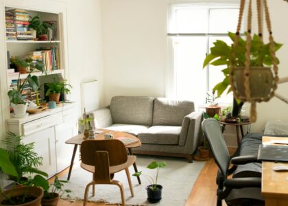 gray fabric loveseat near brown wooden table