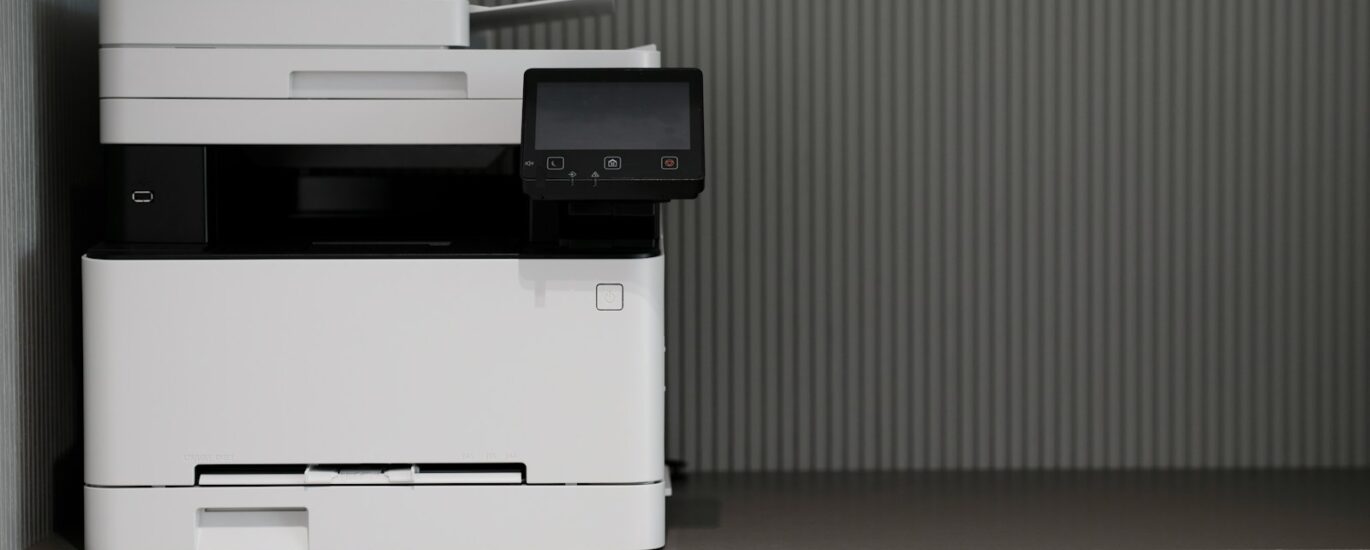 a white and black printer sitting on top of a counter