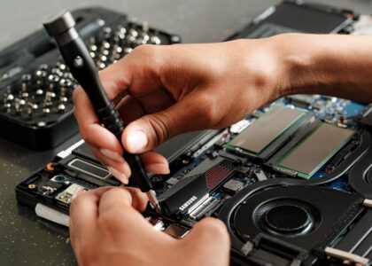 A person is working on a piece of electronics