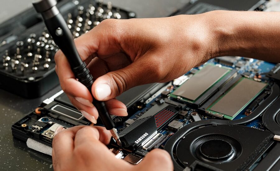 A person is working on a piece of electronics