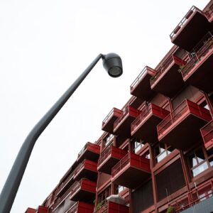 an apartment building with balconies and a street light