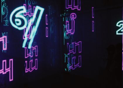 neon signs are lit up in a dark room